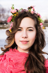 Fototapeta premium Beautiful young girl with a floral ornament in her hair