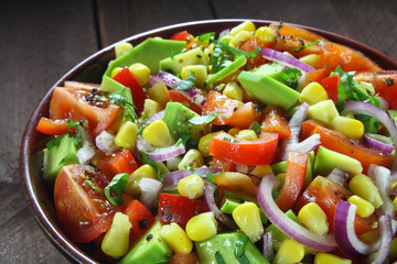 Salad with avocado, tomato, paprika, red onion and corn