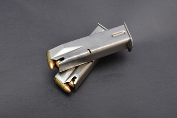 Magazine full of bullets on gray background