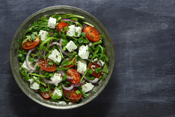 Salad with arugula, tomato, cheese and red onion