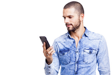 Casual man reading a message on his smartphone, isolated on whit