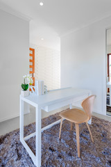 White wooden table and light wooden chair in the modern room
