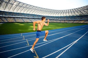 Young sportsman is at large modern stadium