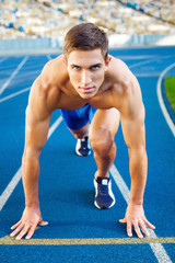 Obraz premium Young sportsman is at large modern stadium
