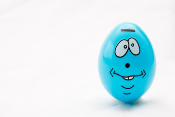blue egg with a face on a white background 