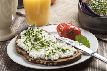 healthy spring summer low fat breakfast with orange juice,coffee,bread,cottage cheese, cress and tomatos