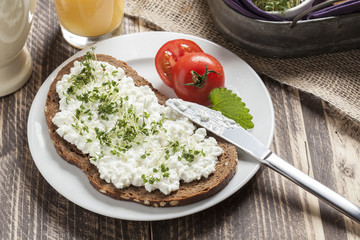 healthy spring summer low fat breakfast with orange juice,coffee,bread,cottage cheese, cress and tomatos