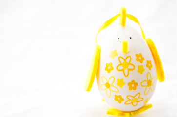 yellow painted egg in shape of a bird 