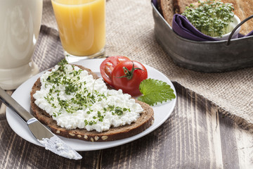 healthy spring summer low fat breakfast with orange juice,coffee,bread,cottage cheese, cress and tomatos