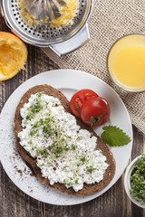 healthy spring summer low fat breakfast with orange juice,coffee,bread,cottage cheese, cress and tomatos