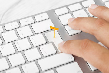 Woman pressing wine delivery button on computer keyboard