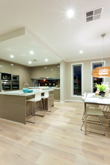 Interior view of a house with wooden floor and kitchen next to t