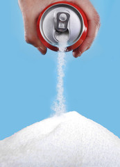 hand holding soda can pouring a crazy amount of sugar in metaphor of sugar content