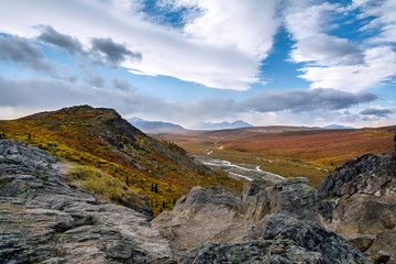 A dramatic break in the clouds above the Savage River valley in Denali National Park during peak Autumn colors.