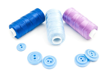 three spools of thread and buttons