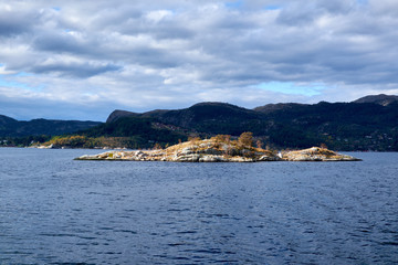Fototapeta premium Very small rock island with single trees situated in Lysefjord Norway