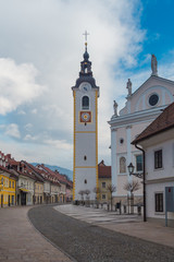 Obraz premium Kamnik, Slovenia - January 25, 2016. Church of the Immaculate Conception with its Tower on the main town street called Sutna.