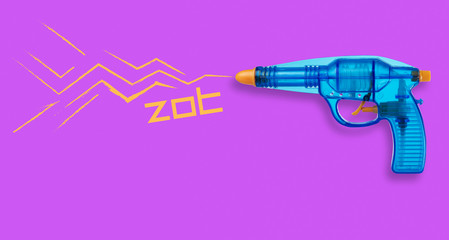 Blue plastic water-gun on violet background