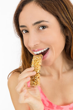 Close up of woman eating a muesli bar
