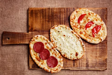 Photo sur Plexiglas Pizzeria Turkish pita bread with cottage cheese, chicken, salami and toma