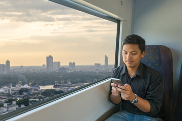 Man use smart phone in sky train