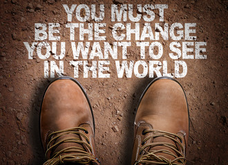 Top View of Boot on the trail with the text: You Must Be The Change You Want To See In The World