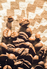 Coffee beans on a flax texture background