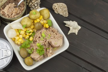 Tuna chunks with vegetables, preparing dietary meals. Fishing industry.
