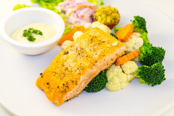 Fried salmon steak with vegetables