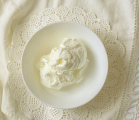 ice cream sundae in a white bowl on a white napkin