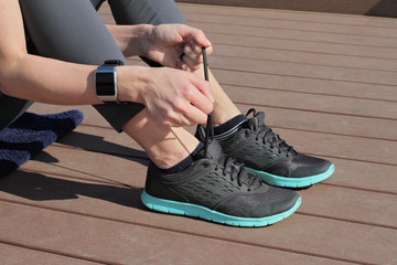 Fitness people using smart watch. Women runner getting ready for jogging. Sport, active lifestyle concept