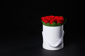 Romantic red roses in a small gift box white round space for the logo, studio shooting, the spring comes,8 March.