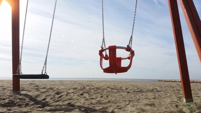 4k Moving swing on the beach