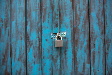 Close up of an antique wooden door painted in blue