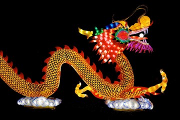 Chinese dragon of light against black aground