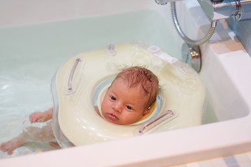 Baby swimming with neck swim ring