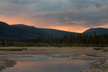 The sky over the river in the sunset light. River Labynkyr. Yakutia. Russia.