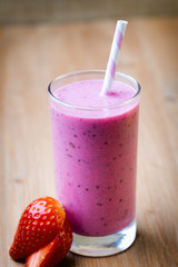 Smoothie, pink juice on the grey  background.