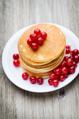 Stack of pancakes with blueberry and fresh berry.