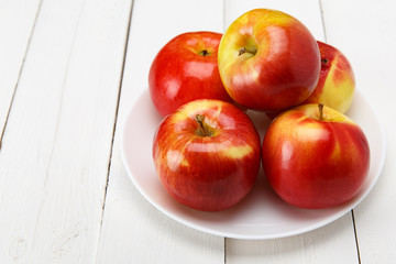 Red apples on a white table