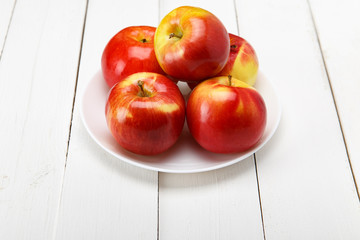 Red apples on a white table