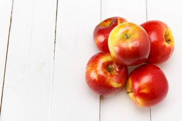 Red apples on a white table