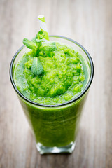 Rucola smoothie, on the grey  background.