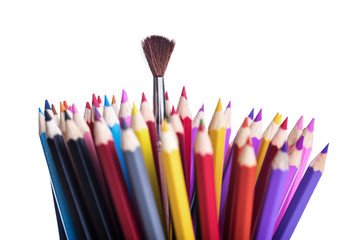 One brush among of color pencils, isolated on white