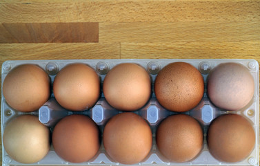 eggs in the package on  wooden table
