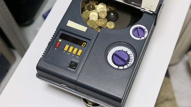 Money poured out of the bag into the machine for counting and sorting coins