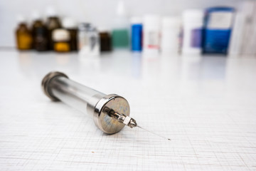 Syringe with glass vials and medications pills