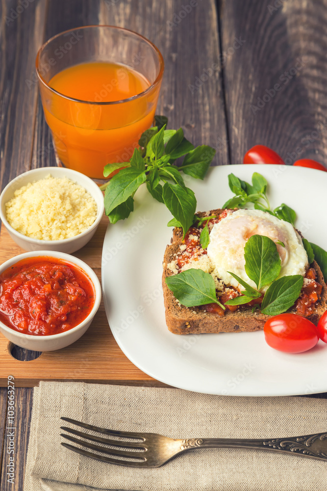 Canvas Prints breakfast toast with poached egg, tomato sauce, basil and parmes