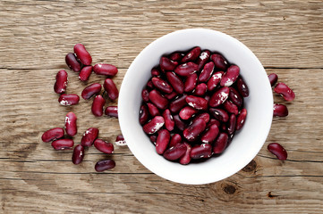 Beans in bowl on wooden table top view