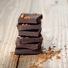 Pile of chocolate pieces on wooden table